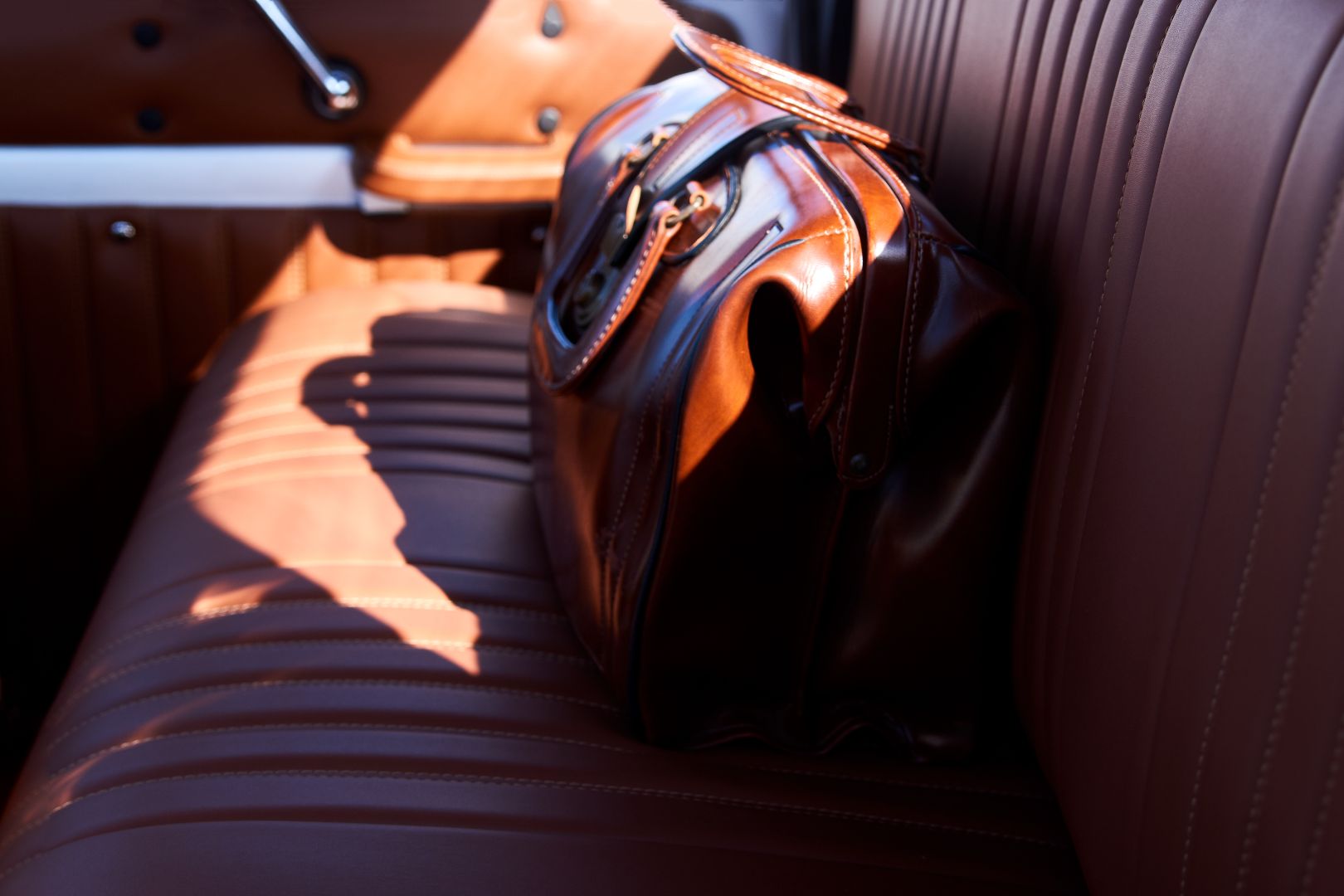 brown leather bag on a car seat